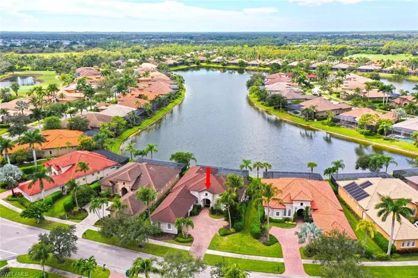 an aerial view of residential houses with outdoor space and swimming pool