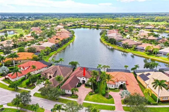 an aerial view of residential houses with outdoor space and swimming pool