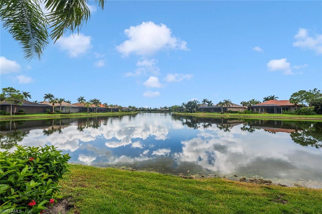 8957 Shenendoah Circle Naples, FL 34113 - Photo 43 of 50 a view of a lake with houses in the background