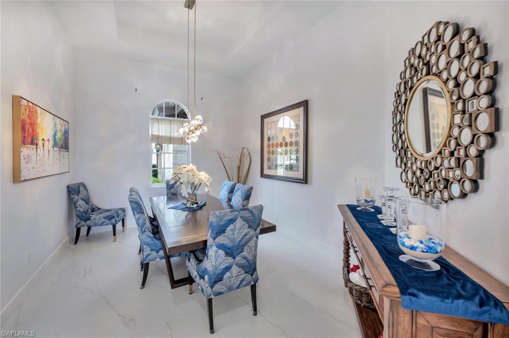 8957 Shenendoah Circle Naples, FL 34113 - Photo 9 of 50 a dining room with furniture and window