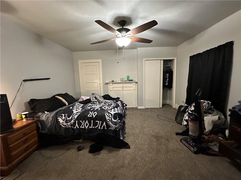 243 Pennsylvania Avenue Rochester, PA 15074 - Photo 14 of 18 a bedroom with bed and a chandelier