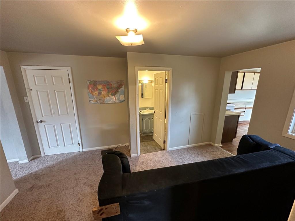 243 Pennsylvania Avenue Rochester, PA 15074 - Photo 3 of 18 a bedroom with a bed and a lamp