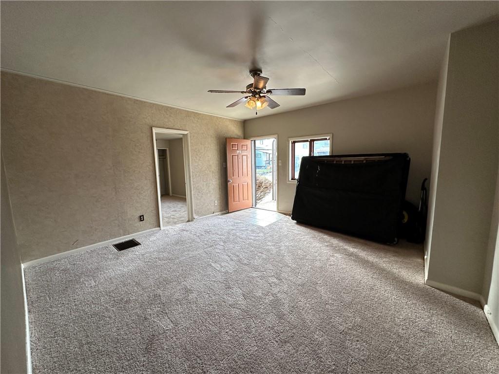 243 Pennsylvania Avenue Rochester, PA 15074 - Photo 4 of 18 a living room with a bed and a chandelier