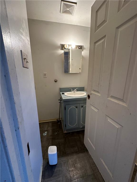 243 Pennsylvania Avenue Rochester, PA 15074 - Photo 10 of 18 a bathroom with a sink a toilet and a mirror
