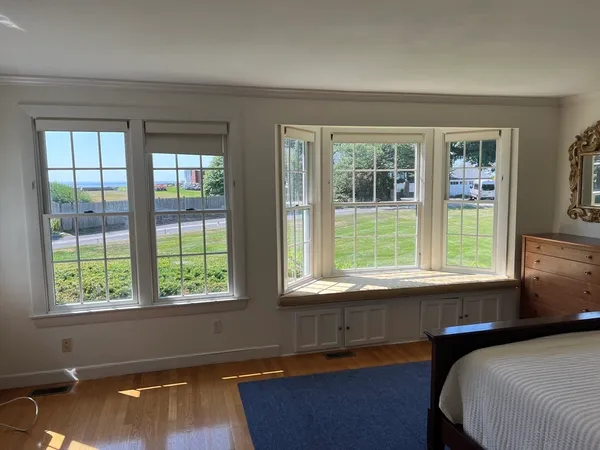 a bed sitting in a bedroom next to a window