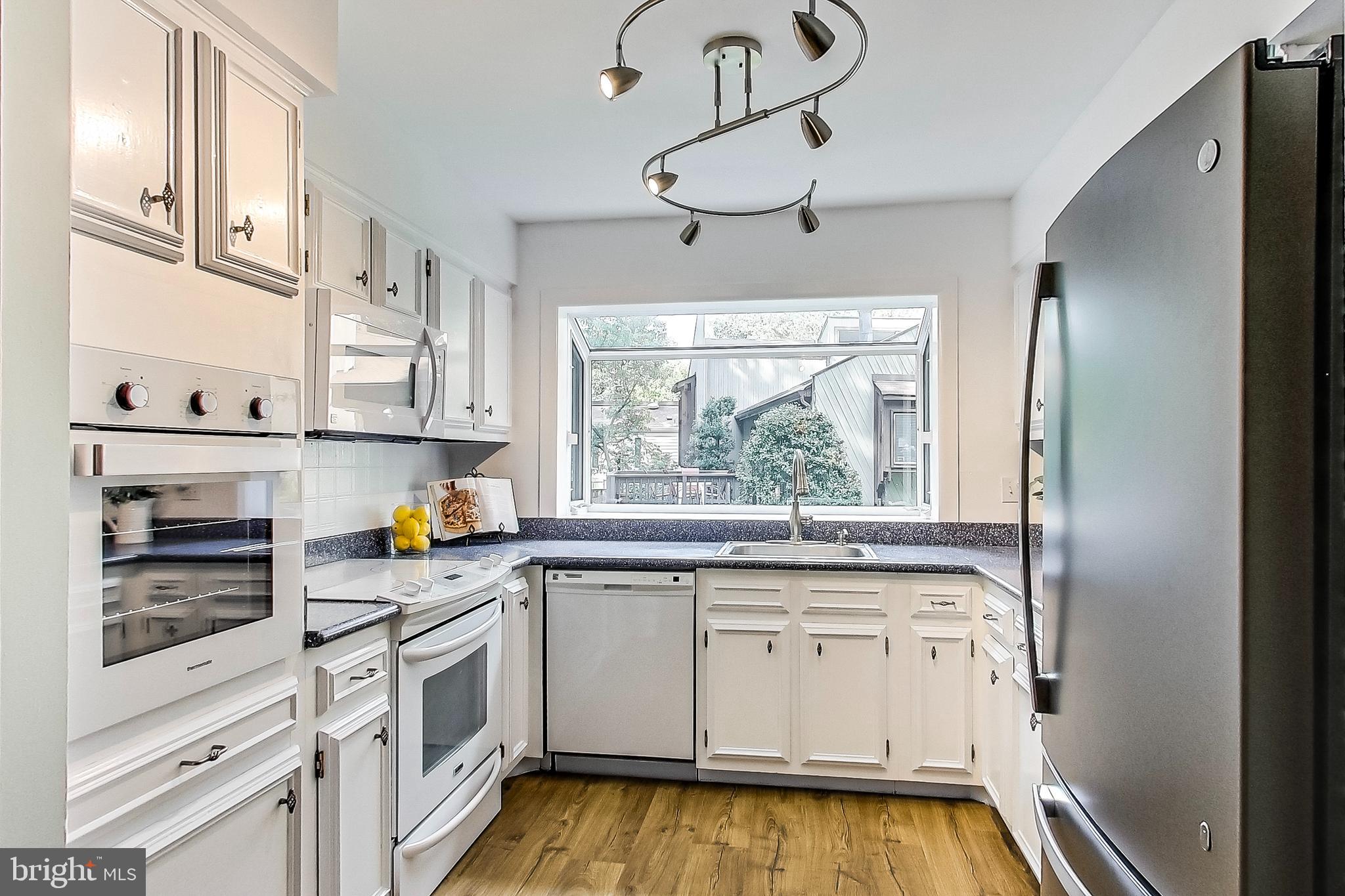 2452 Freetown Drive Reston, VA 20191 - Photo 13 of 69 Kitchen with Laminate Plank Flooring
