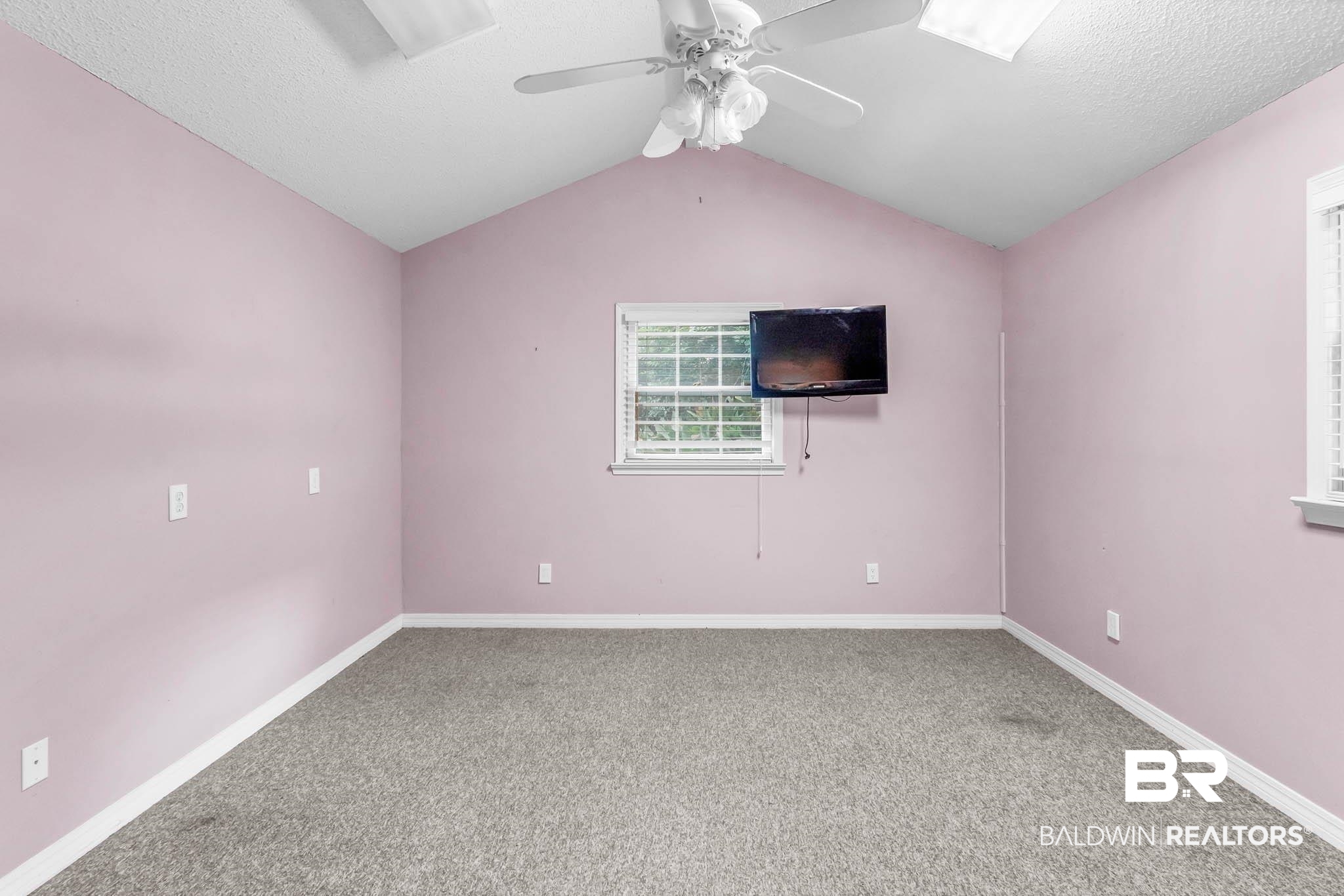 309 West Brandy Run Road Mobile, AL 36608 - Photo 67 of 100 Carpeted empty room featuring a textured ceiling, vaulted ceiling, and ceiling fan