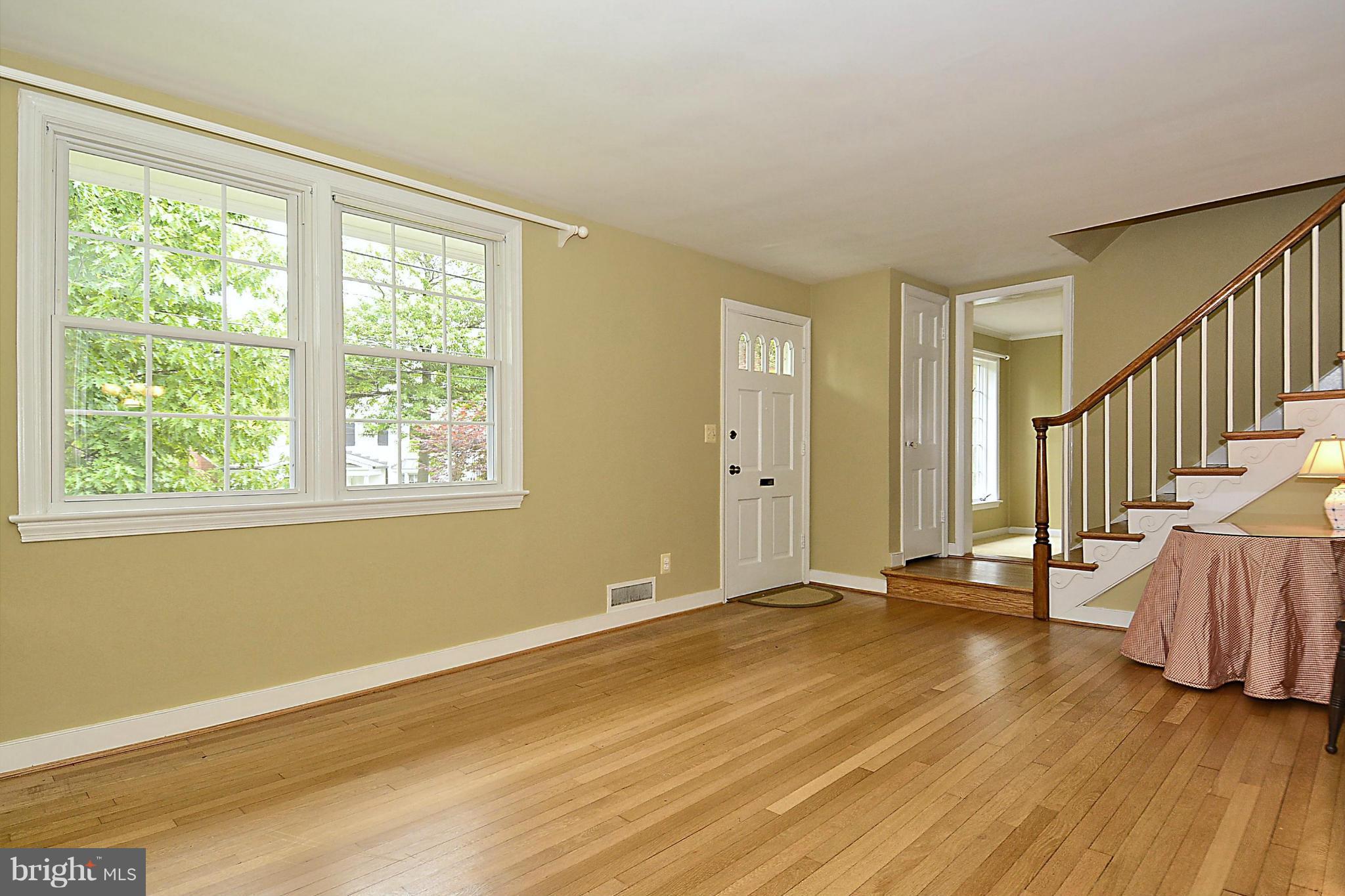 5004 Allan Road Bethesda, MD 20816 - Photo 5 of 30 a view of an empty room with wooden floor and a window
