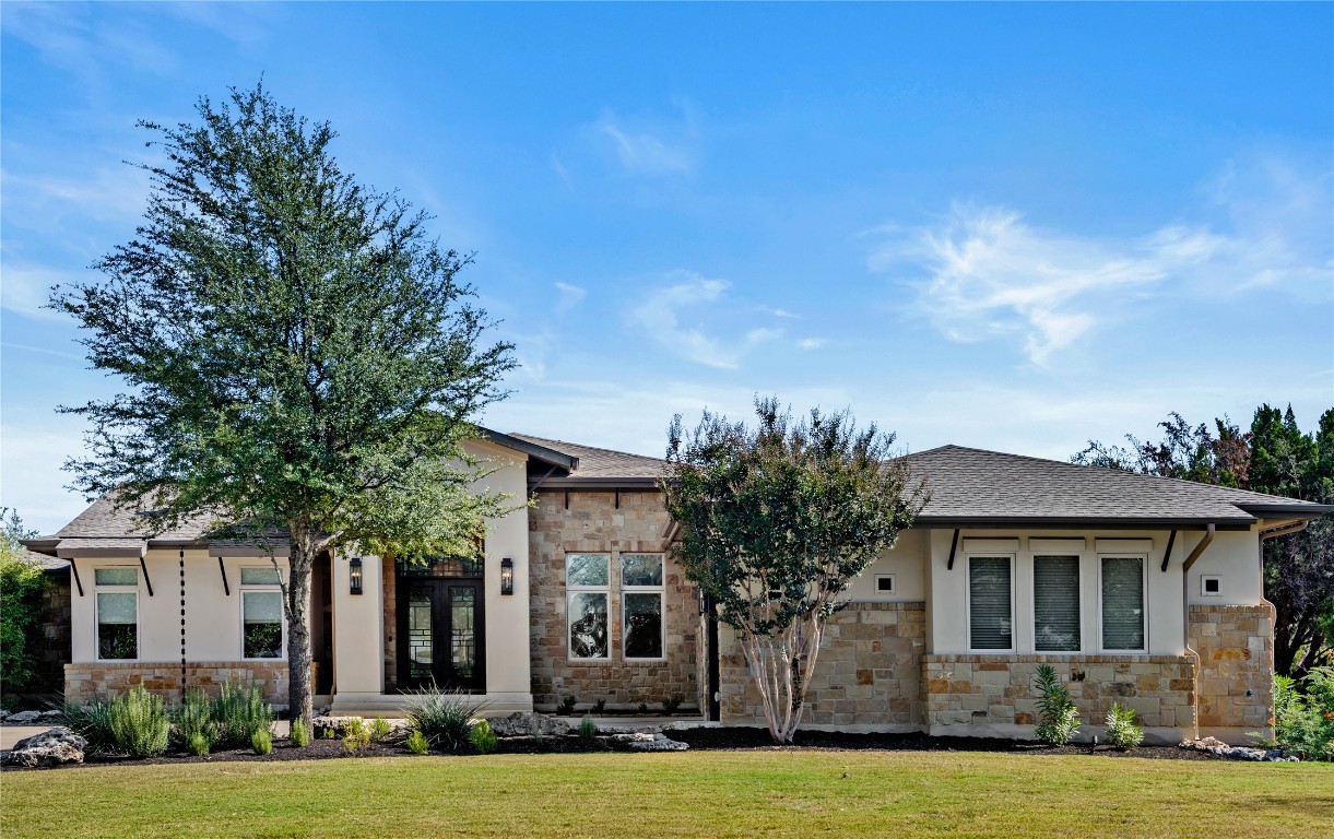 a front view of a house with a yard
