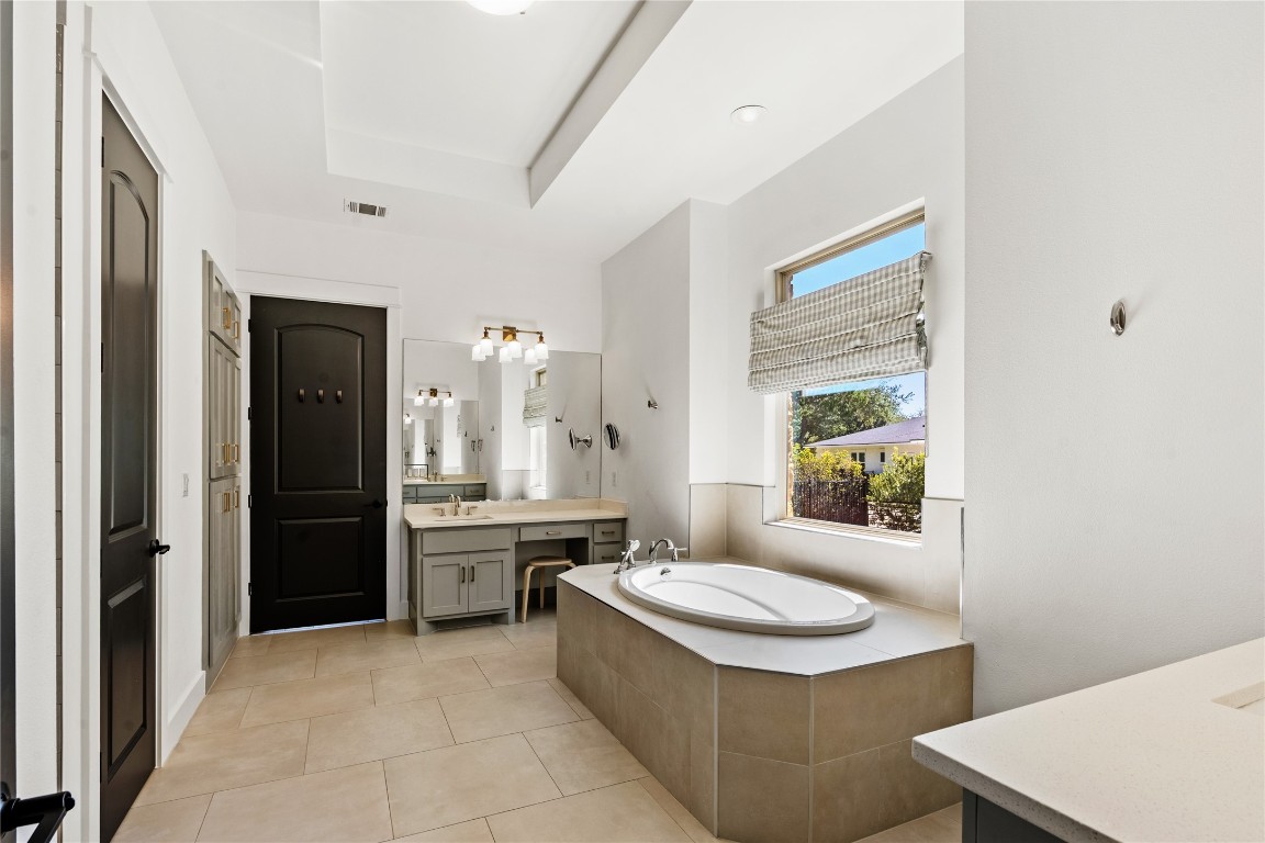 7909 Orisha Drive Austin, TX 78739 - Photo 17 of 40 a bathroom with a sink a toilet and shower