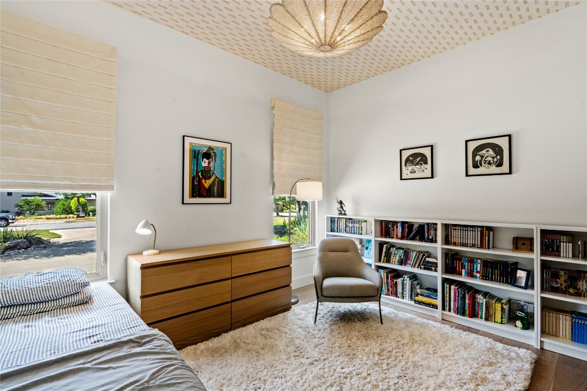 7909 Orisha Drive Austin, TX 78739 - Photo 19 of 40 a living room with furniture and a book shelf