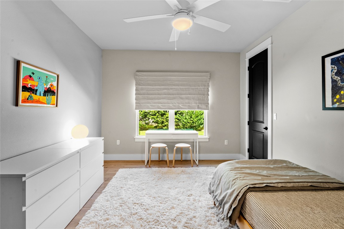 7909 Orisha Drive Austin, TX 78739 - Photo 21 of 40 a bedroom with a bed and a large window