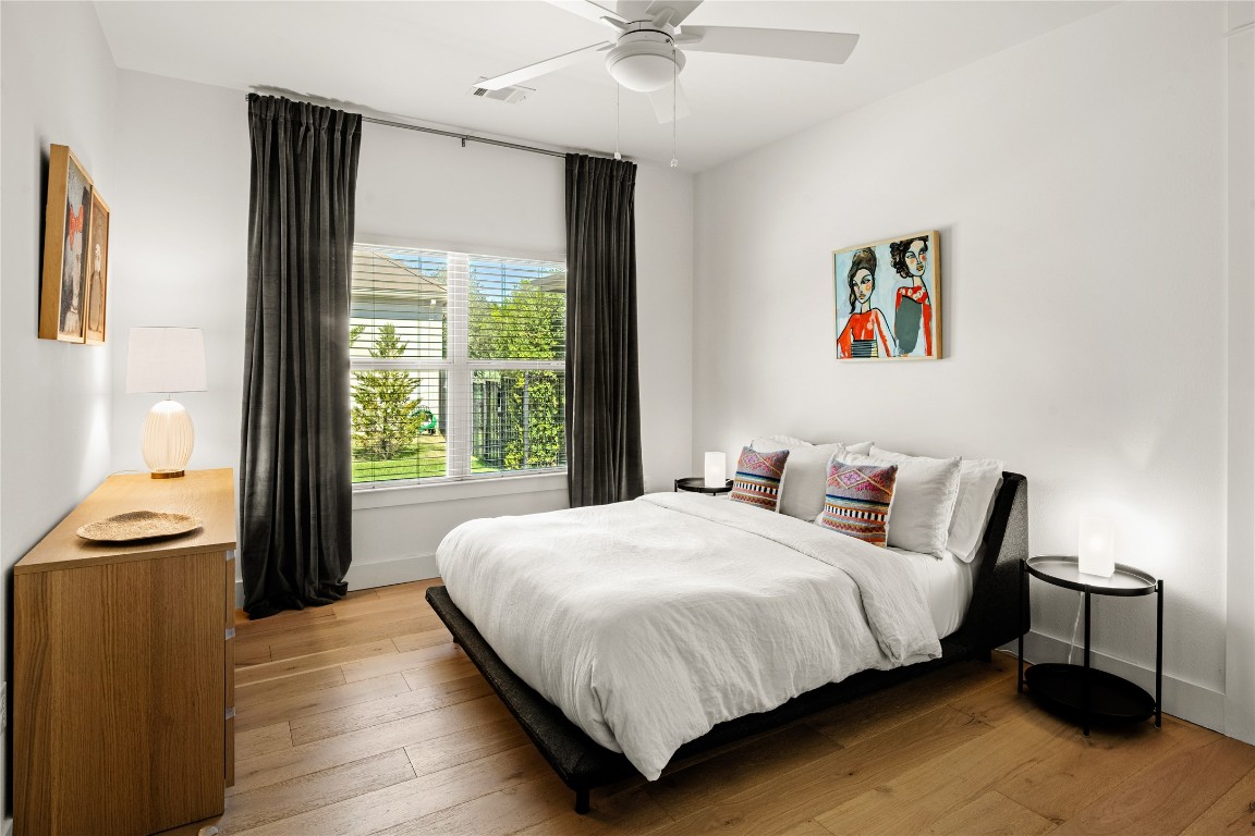 7909 Orisha Drive Austin, TX 78739 - Photo 22 of 40 a bedroom with a bed and a chandelier