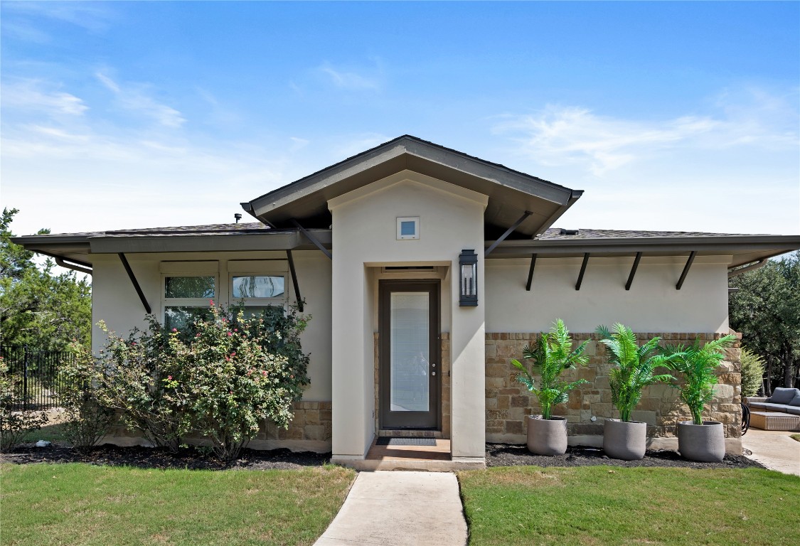 7909 Orisha Drive Austin, TX 78739 - Photo 28 of 40 a front view of a house with a garden