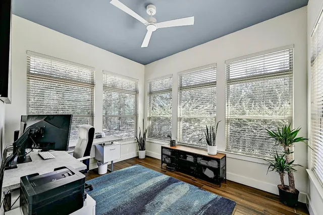a bedroom with a bed and a flat tv screen on the dresser