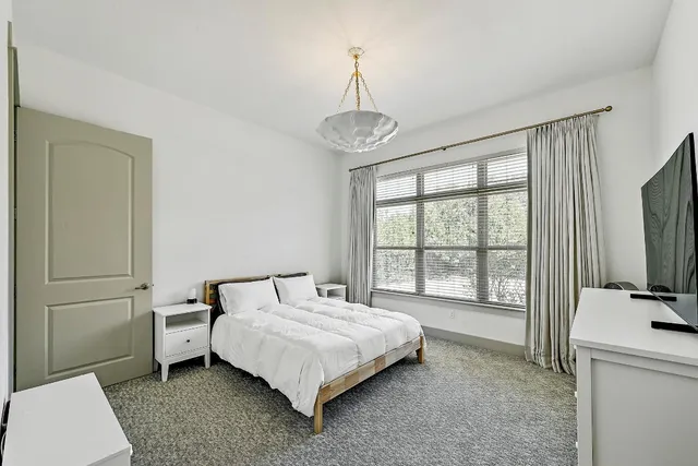 a bathroom with a bathtub shower sink vanity mirror and toilet