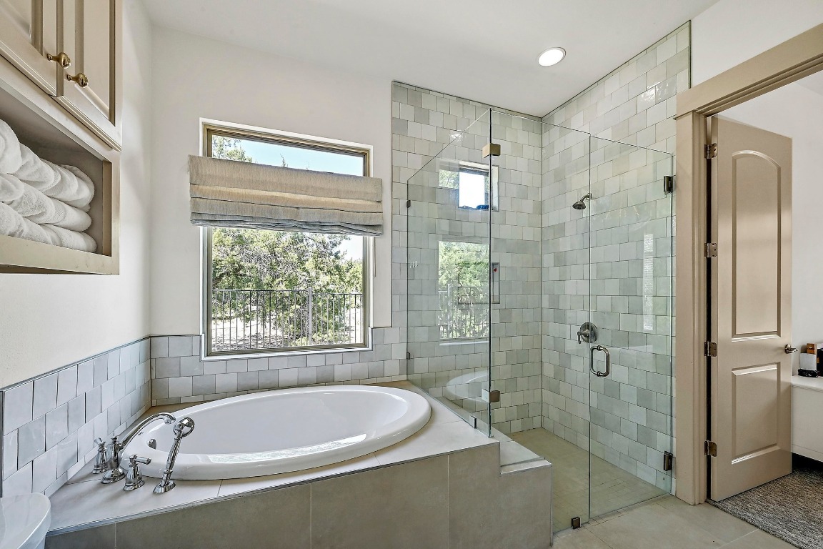 7909 Orisha Drive Austin, TX 78739 - Photo 34 of 40 a bathroom with a tub a sink and a window