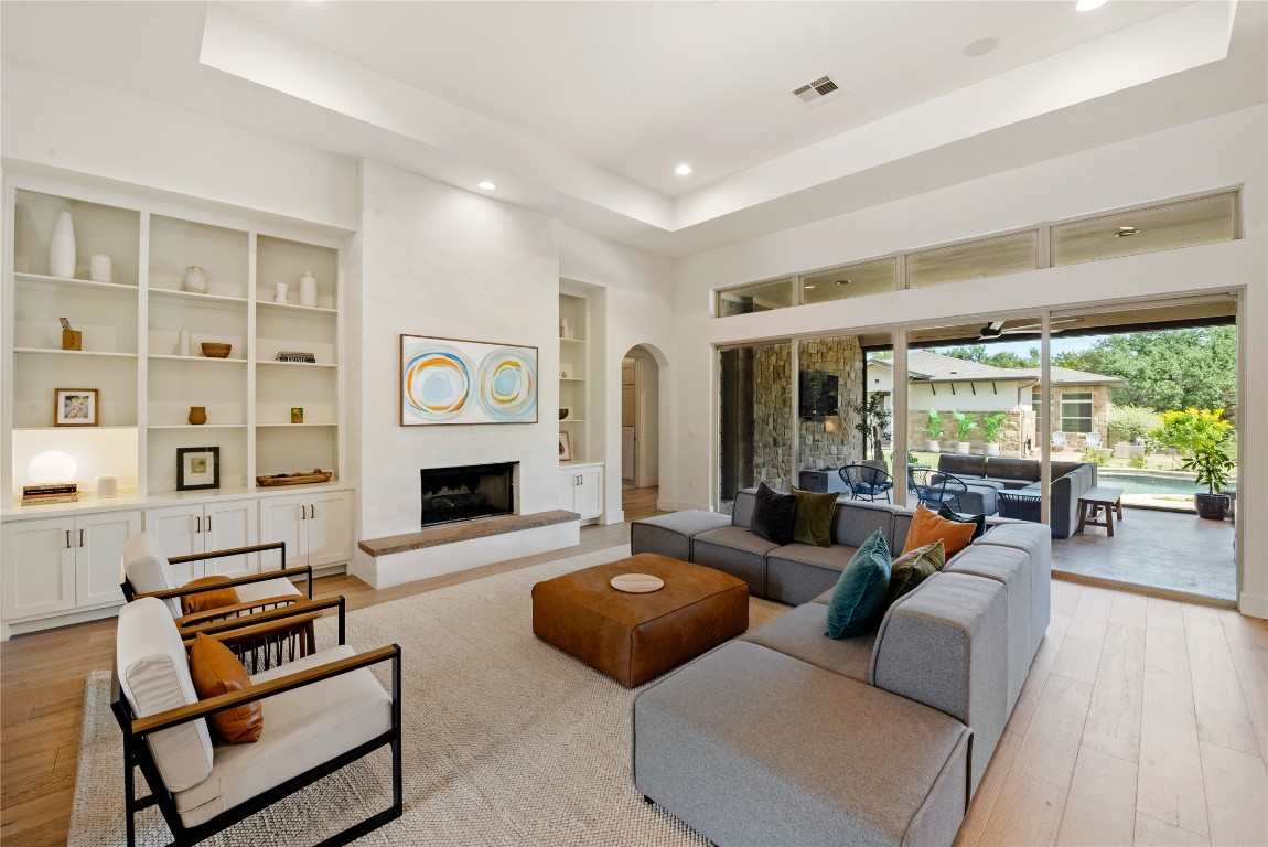 7909 Orisha Drive Austin, TX 78739 - Photo 6 of 40 a living room with furniture and a fireplace