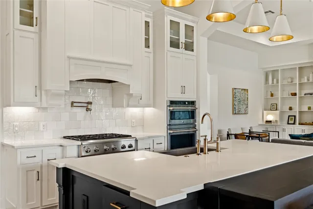 a kitchen with a stove a sink and a refrigerator