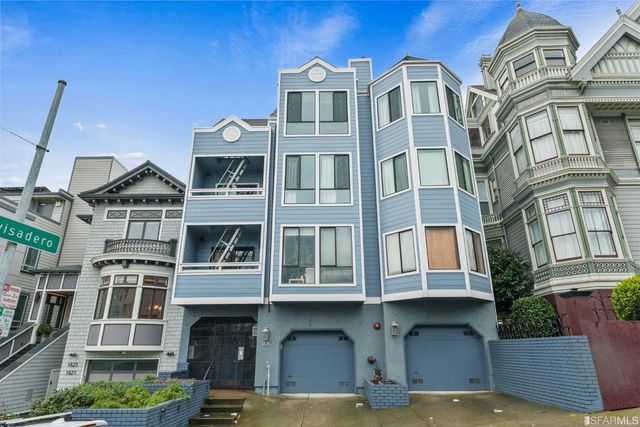 a front view of a building with a lot of windows