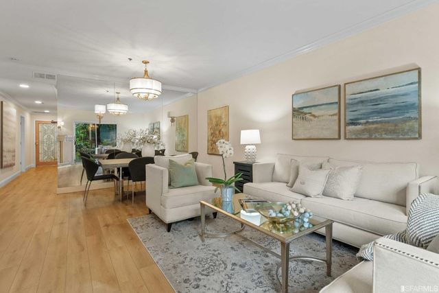 a living room with furniture and a chandelier
