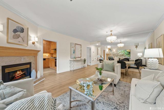 a living room with furniture a fireplace and a table