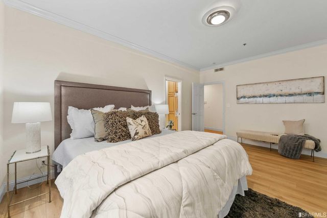 a bedroom with a bed and a mirror