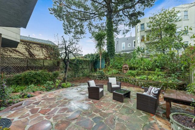 a view of a patio with a chairs and table in a patio