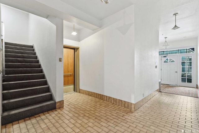 a view of a hallway with wooden floor and entryway