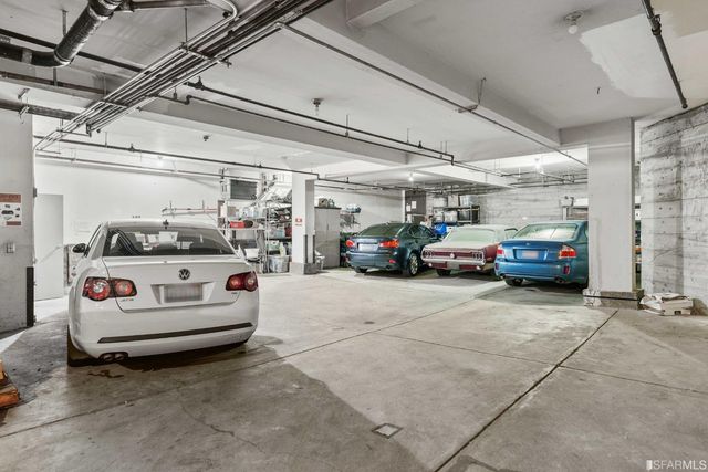 a view of parking garage with cars parked