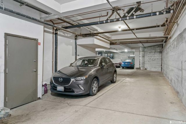 a view of parking garage with cars parked