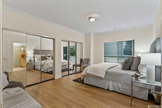 a bedroom with a bed and large mirror