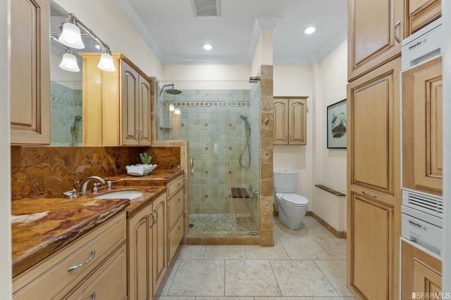a bathroom with a granite countertop sink toilet and shower