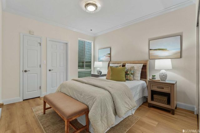 a bedroom with a bed and a chair