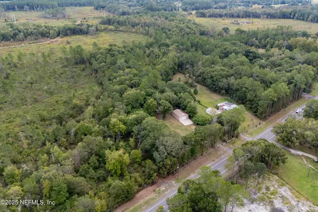 an aerial view of a houses with a yard