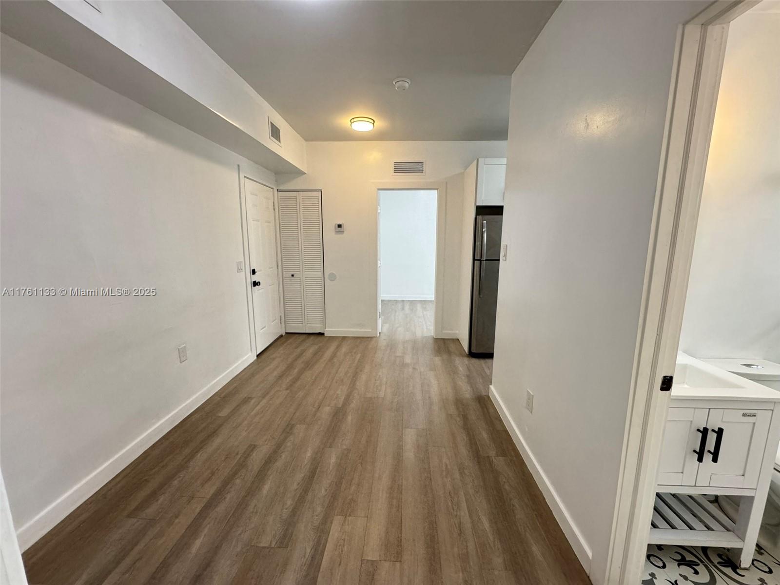 1936 Southwest 2nd Street, Unit 9 Miami, FL 33135 - Photo 11 of 14 a view of a hallway with wooden floor and closet