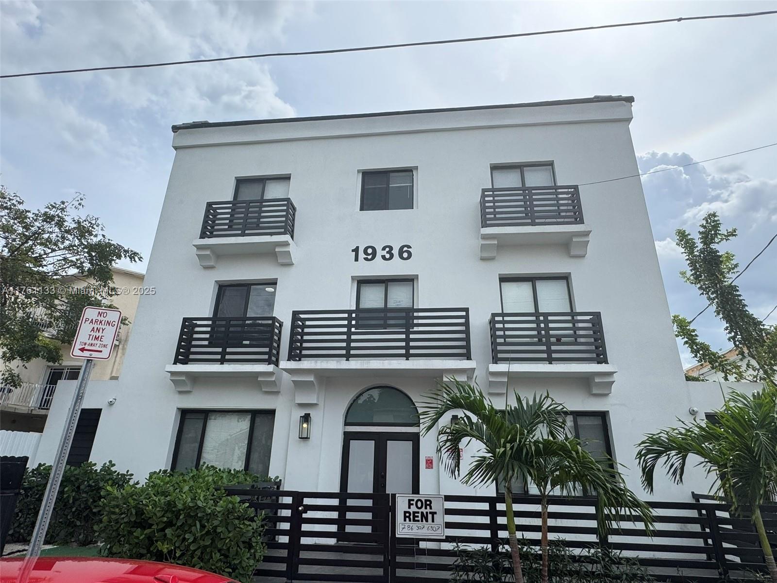 1936 Southwest 2nd Street, Unit 9 Miami, FL 33135 - Photo 14 of 14 a front view of a residential apartment building with a yard and potted plants