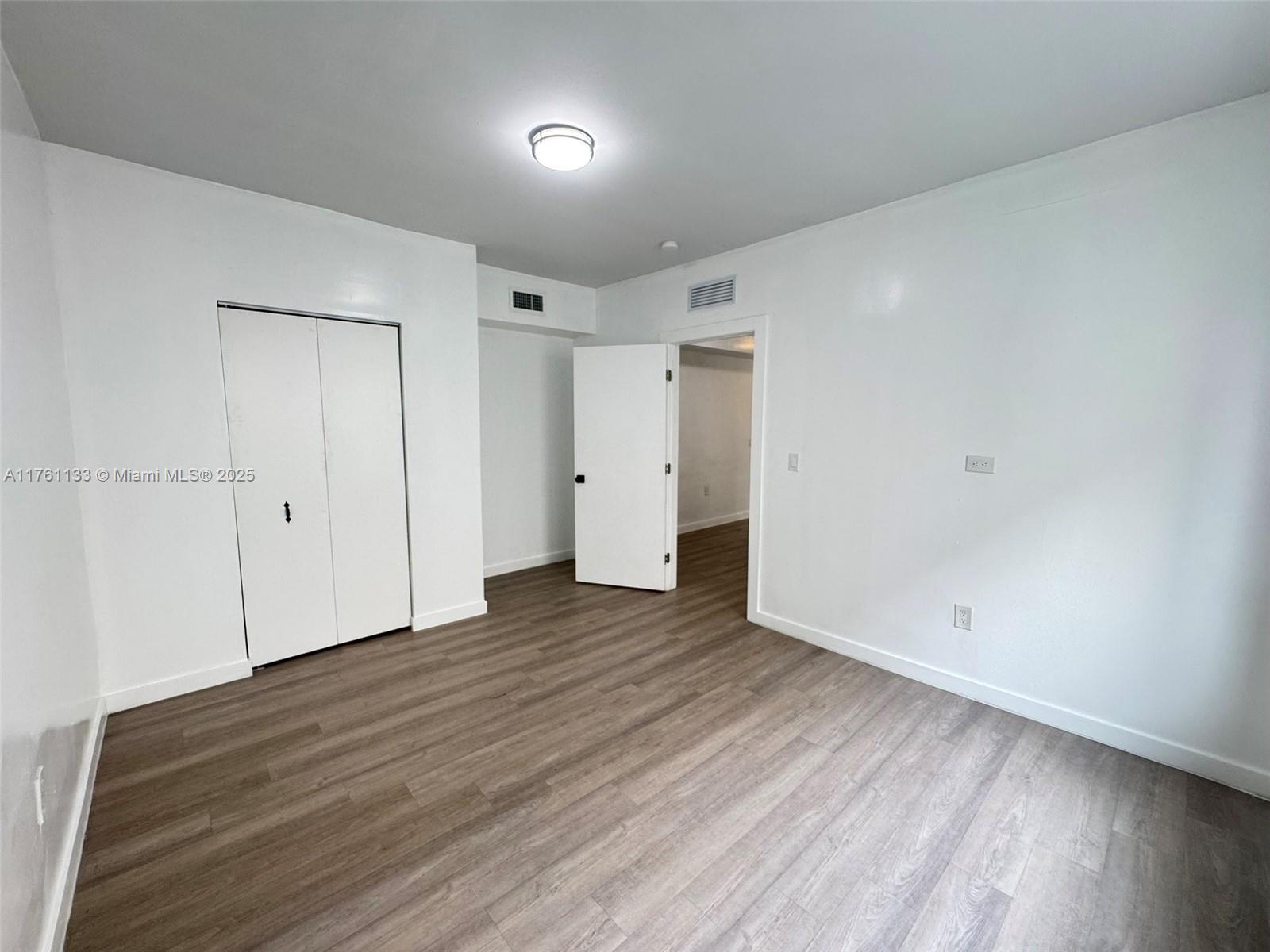 1936 Southwest 2nd Street, Unit 9 Miami, FL 33135 - Photo 4 of 14 a view of an empty room with wooden floor
