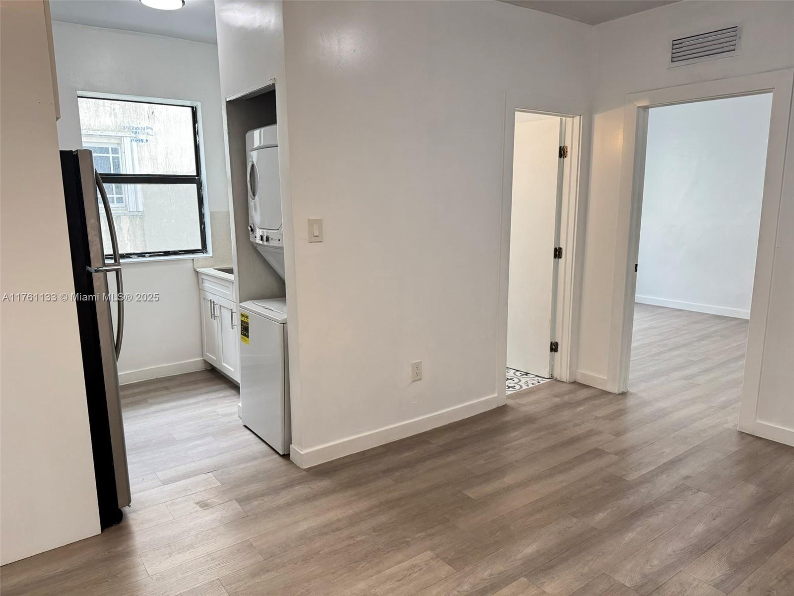1936 Southwest 2nd Street, Unit 9 Miami, FL 33135 - Photo 7 of 14 a view of a kitchen with wooden floor and electronic appliances