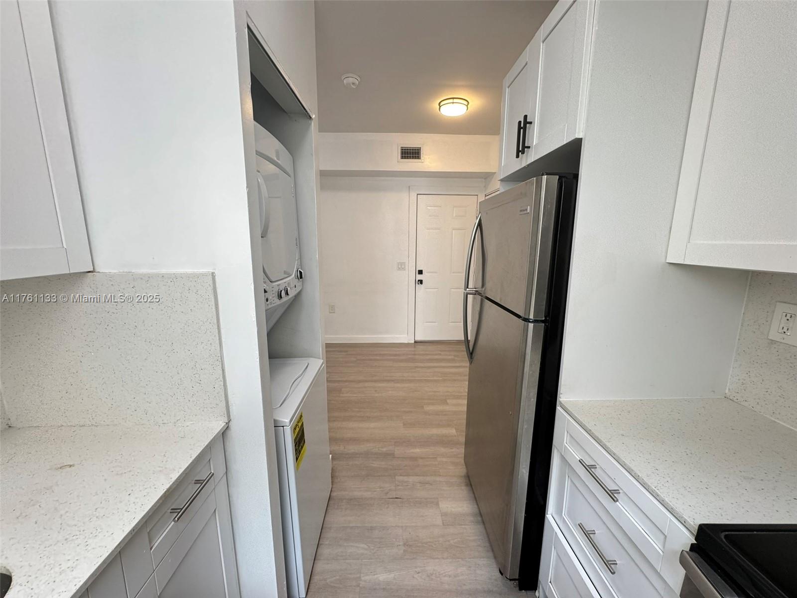 1936 Southwest 2nd Street, Unit 9 Miami, FL 33135 - Photo 8 of 14 a kitchen with a refrigerator and a sink
