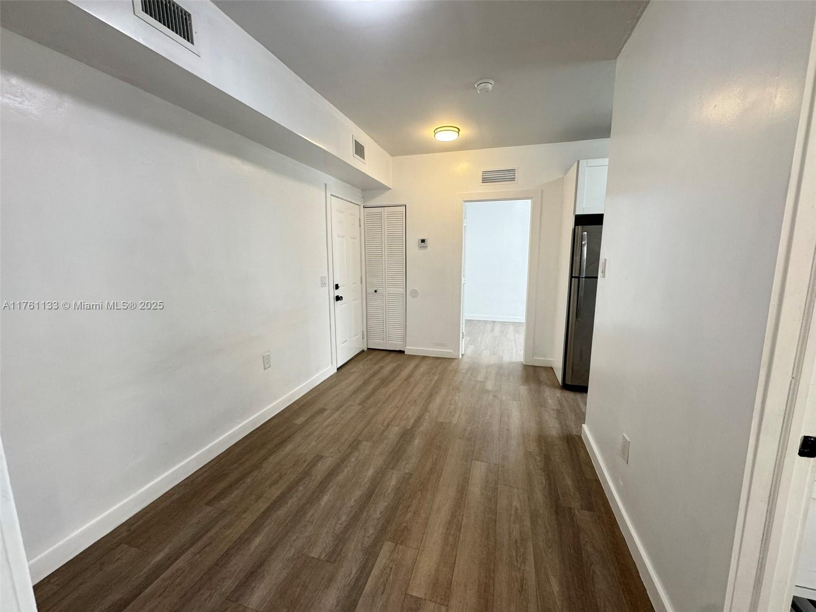 1936 Southwest 2nd Street, Unit 9 Miami, FL 33135 - Photo 9 of 14 a view of a hallway with wooden floor