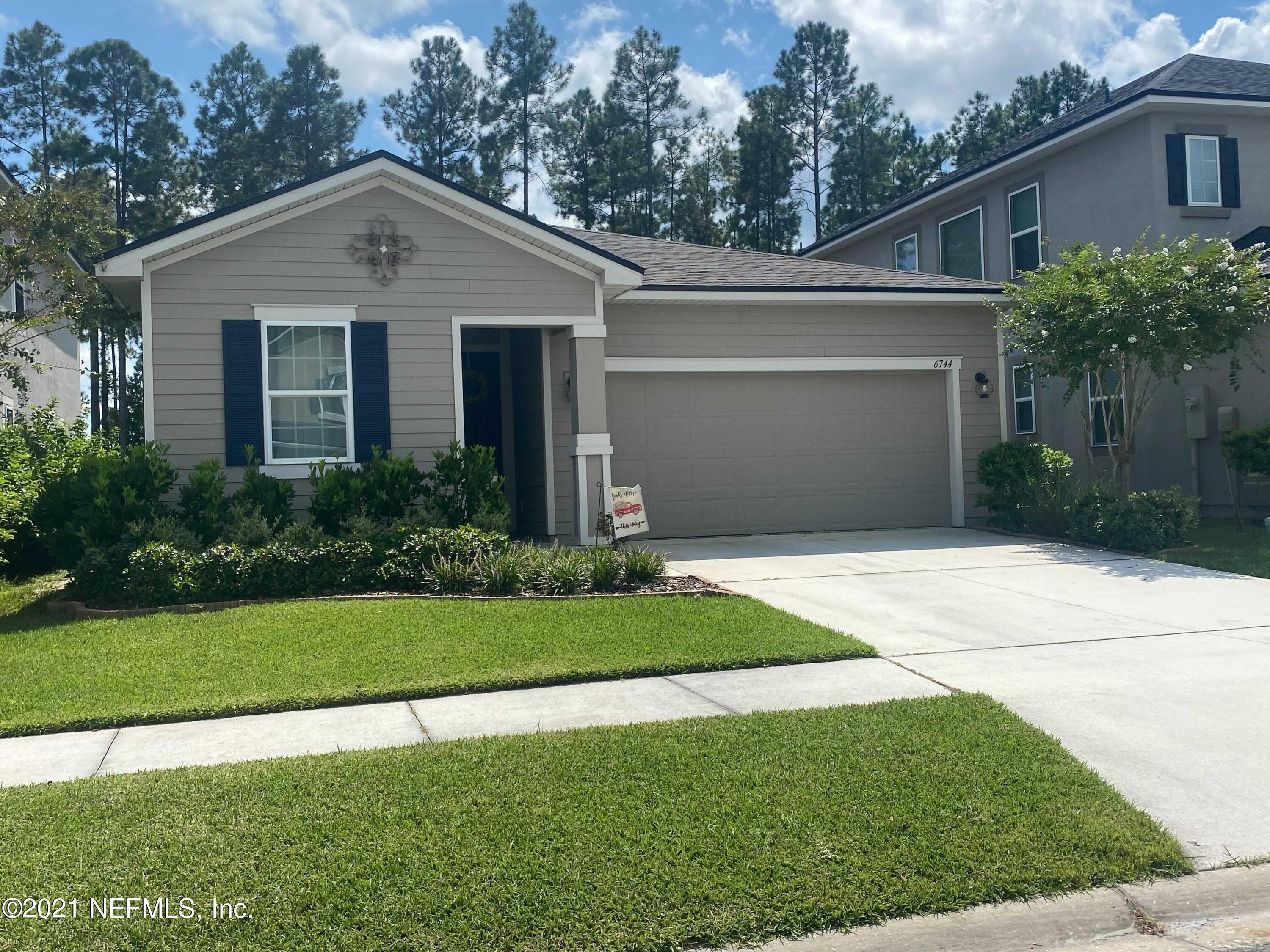 6744 Azalea Park Road Jacksonville, FL 32259 - Photo 1 of 1 a front view of a house with a yard and garage