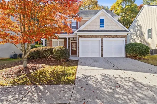 a front view of a house with a yard and garage