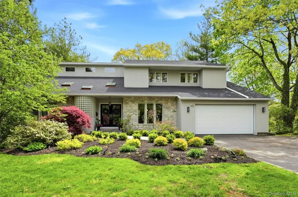a front view of house with a garden