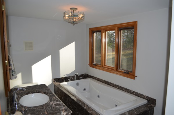 15 Bay Path Road Belchertown, MA 01007 - Photo 14 of 30 a bathroom with a tub sink and mirror