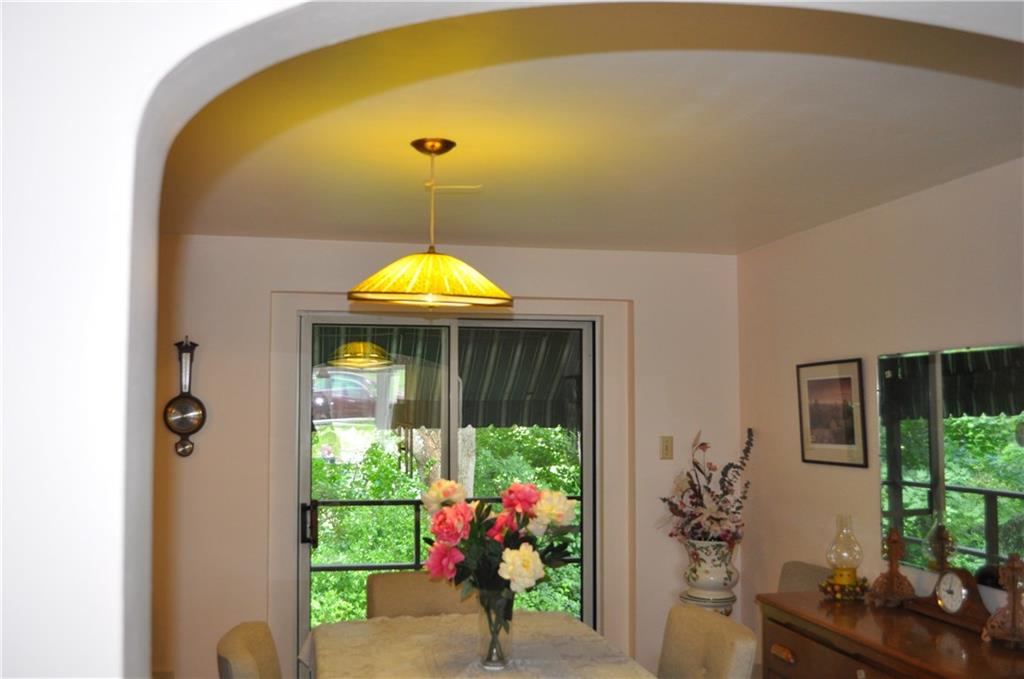 224 Johnston Road Pittsburgh, PA 15235 - Photo 5 of 23 A curved archway leads to the formal dining room. Sliding doors go directly to the awning covered deck.