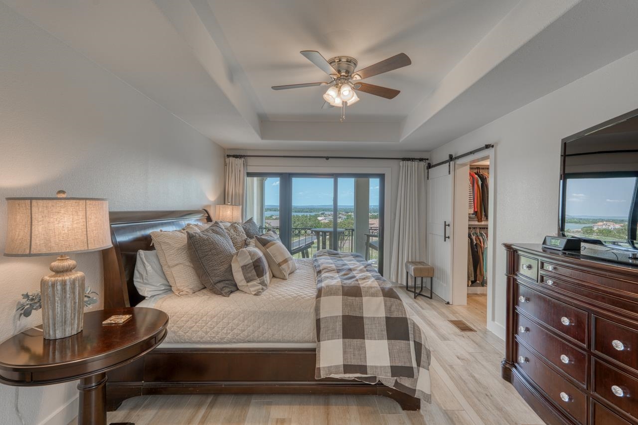 3305 Close Call Horseshoe Bay, TX 78657 - Photo 13 of 30 a bedroom with a large bed and a chandelier