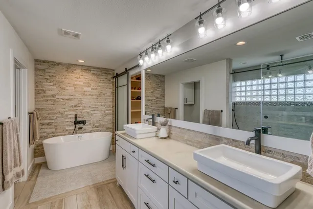 a bathroom with a bathtub and a shower