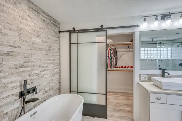 a view of walk in closet with clothes