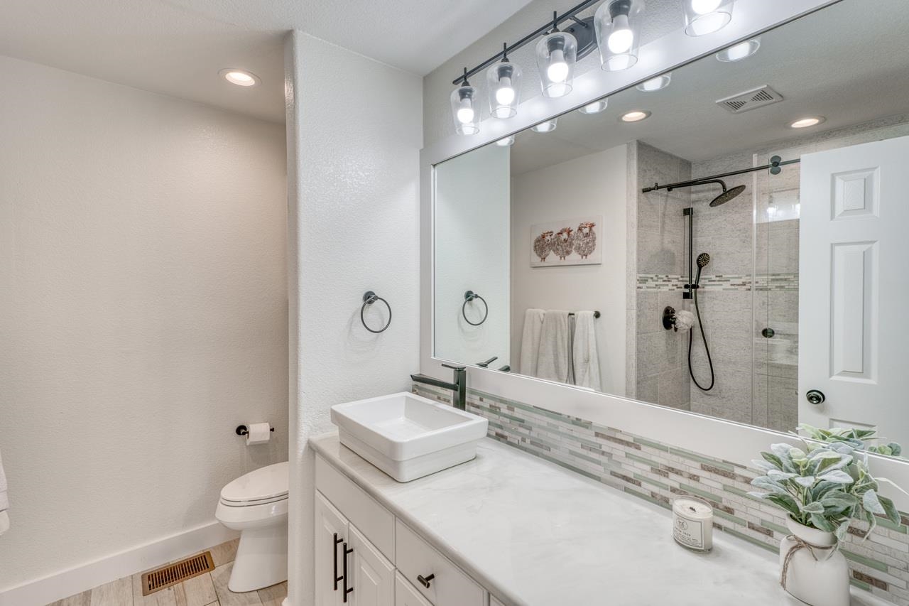 3305 Close Call Horseshoe Bay, TX 78657 - Photo 20 of 30 a spacious bathroom with a granite countertop sink a toilet and shower